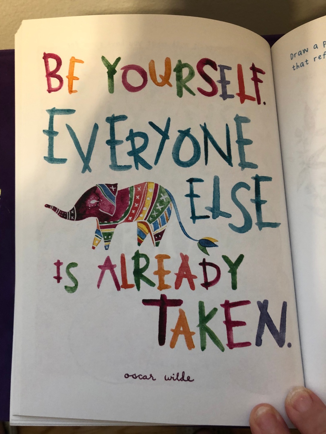Colorful printed page that says, "Be Yourself. Everyone else is already taken." OscarWilde. It has a multicolored elephant in the center.